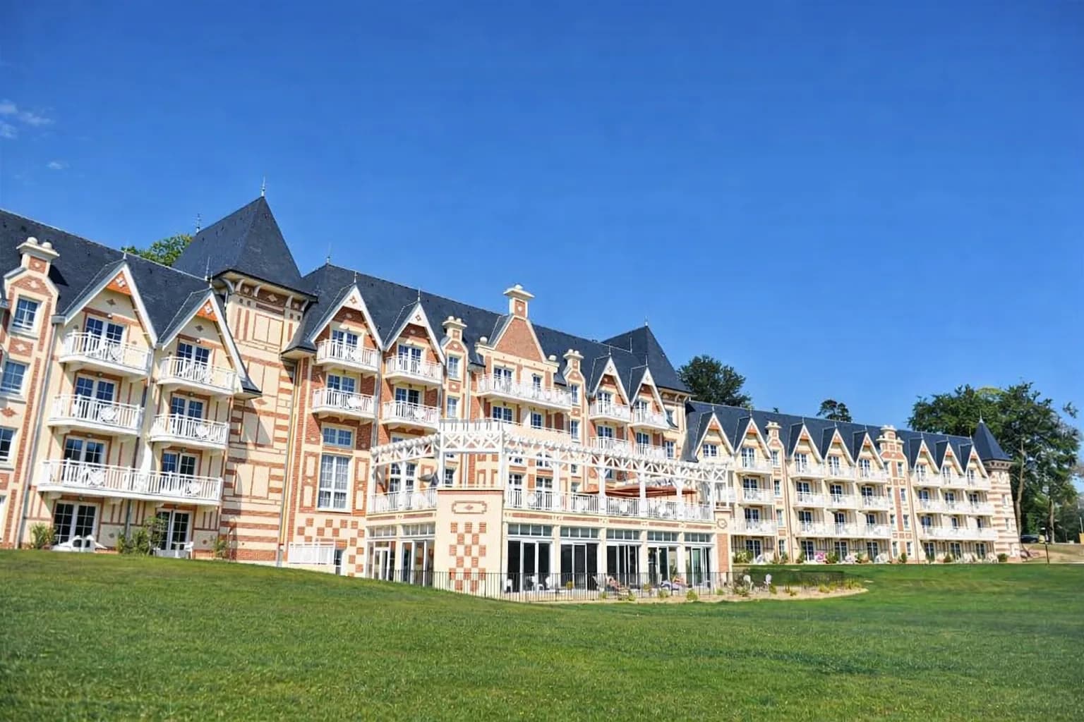 Façade Belle Époque de la résidence B'O Cottage, à colombages et briques, vue depuis la pelouse