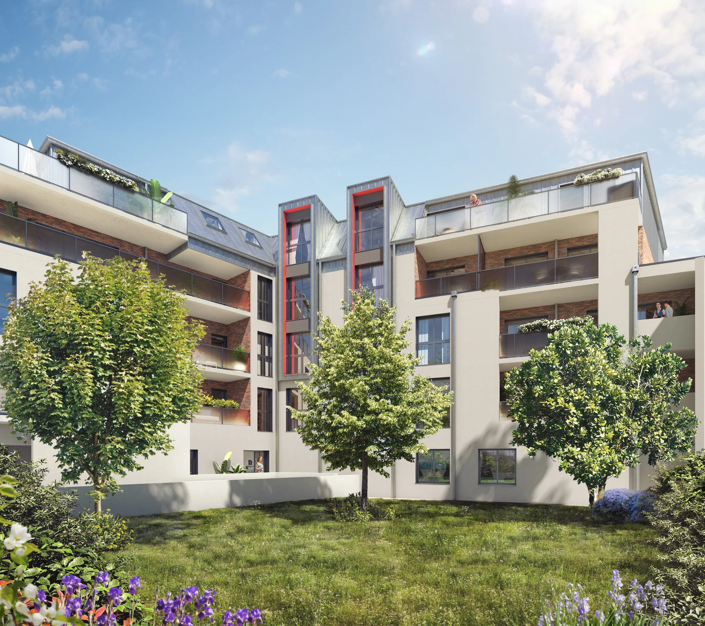 La résidence côté jardin : balcons filants, toitures en zinc et terrasses d’attique, jeunes arbres et pelouse au premier plan