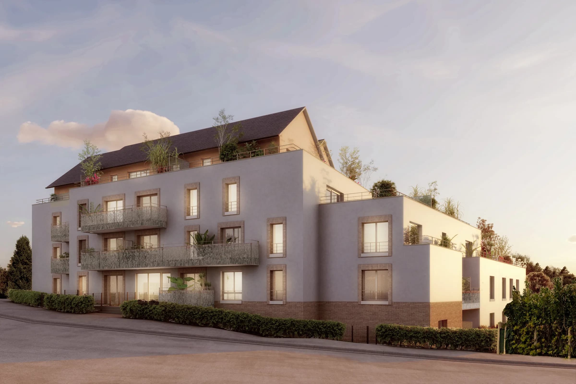 La résidence vue depuis la rue, ses balcons filants et ses terrasses d’attique plantées, parmi les maisons de brique du quartier