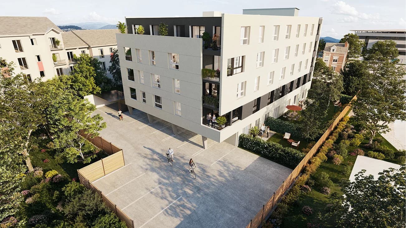 Reverso Mathilde à Rouen : immeuble blanc et bardage noir autour d'une cour plantée, perspective aérienne